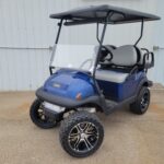 2024 CLUB CAR V4L GAS LIFTED GOLF CART, BLUE IN COLOR, GREY SEATS, BLACK LONG TOP, GAS ENGINE, TURNSIGNALS, HORN, BRAKE LIGHTS, MIRROR, WARRANTY